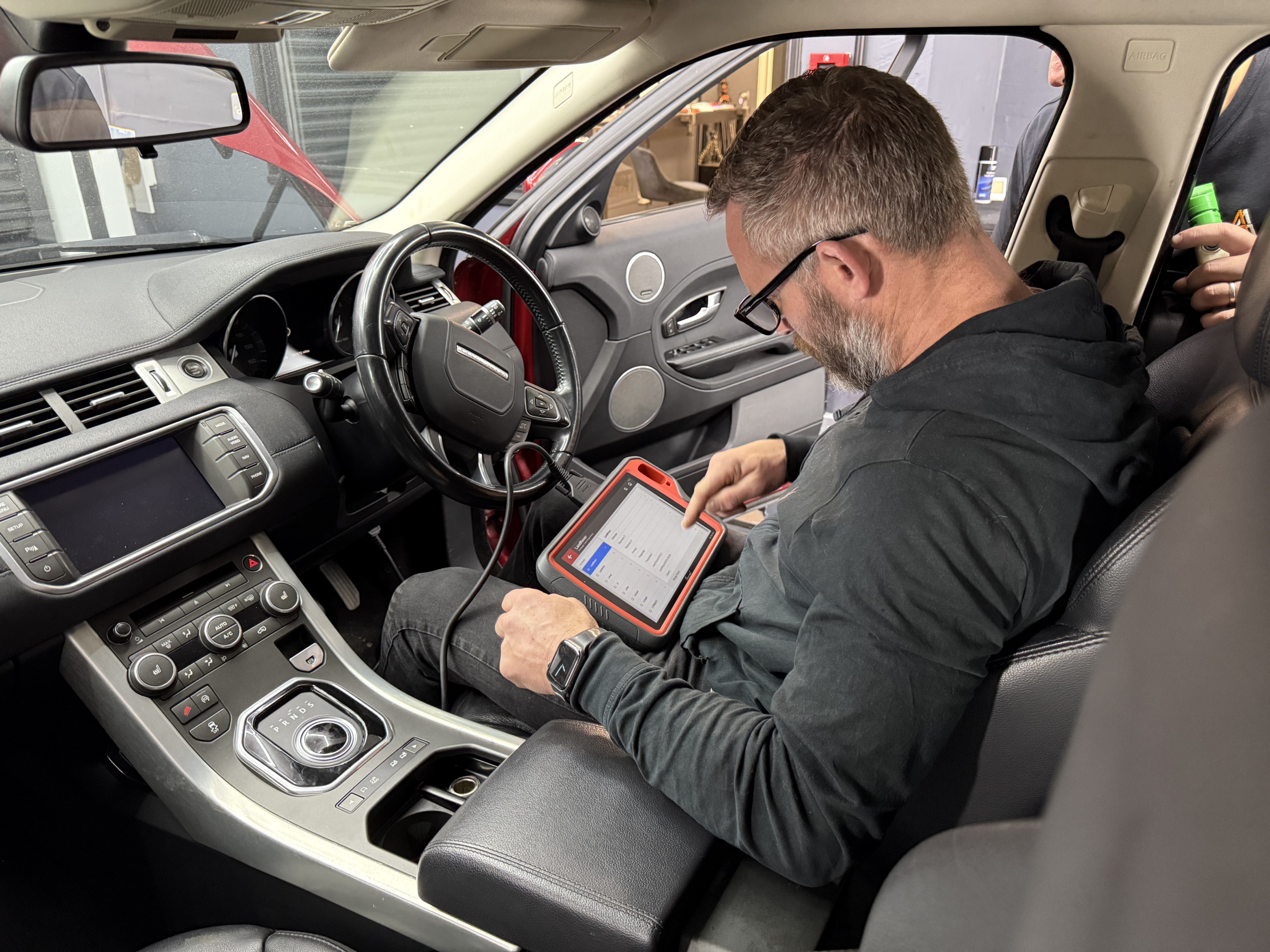 Technician diagnosing and programming lost keys
