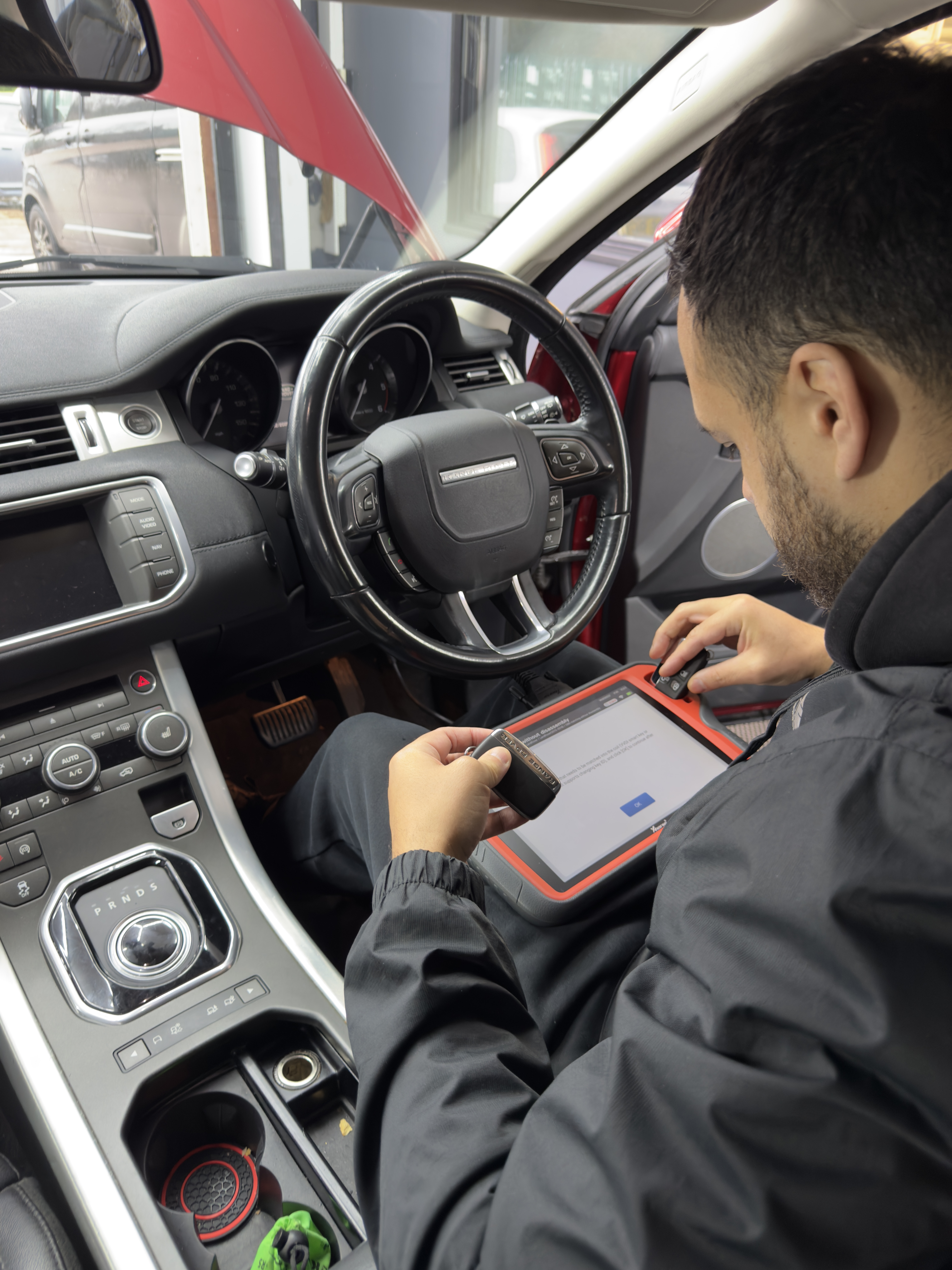 Technician programming a spare key for a Range Rover